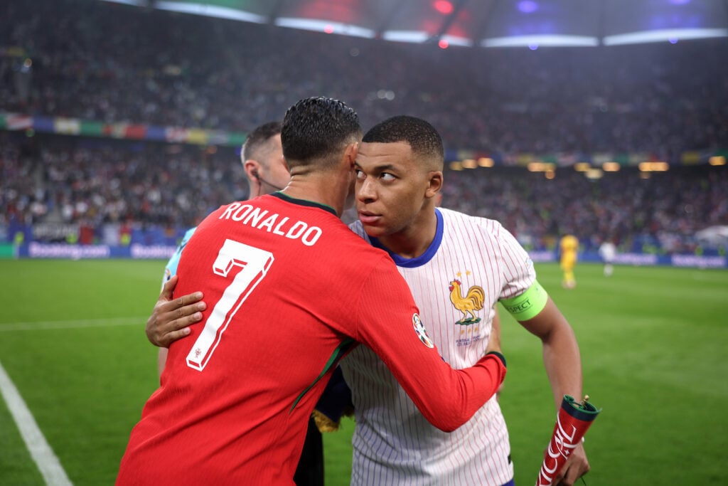 Kylian Mbappe of France shakes hands with Cristiano Ronaldo of Portugal during the coin toss during the UEFA EURO 2024 quarter-final match between Portugal and France at Volksparkstadion.