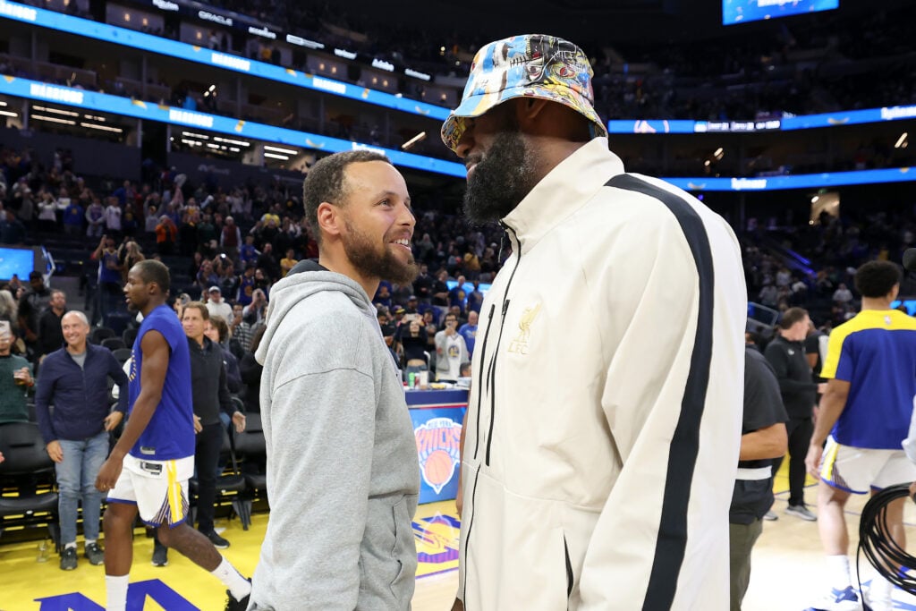 Stephen Curry #30 of the Golden State Warriors talks with LeBron James #23 of the Los Angeles Lakers after their preseason game at Chase Center.