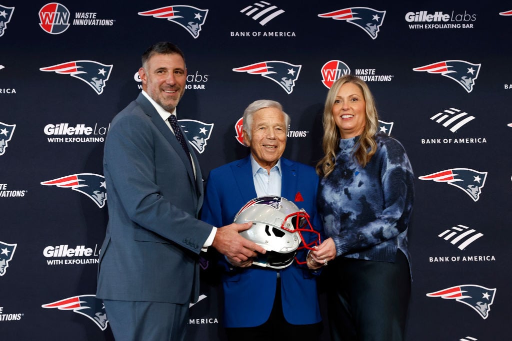 Mike Vrabel, new head coach for the New England Patriots, Patriots CEO Robert Kraft, and Vrabel's wife Jen pose for a photo after the introductory press conference at Gillette Stadium.