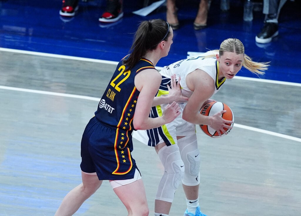 The Dallas Wings guard Paige Bueckers (5) is guarded by Indiana Fever guard Caitlin Clark (22) on July 13, 2025, at Gainbridge Fieldhouse in Indianapolis, Indiana.