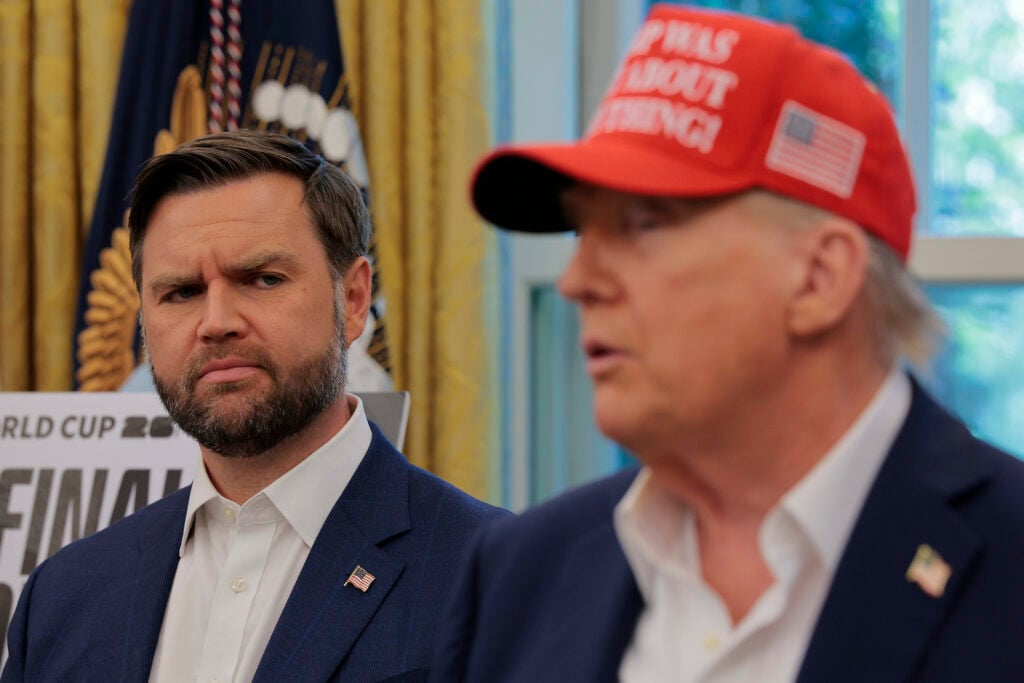 Vice President JD Vance looks at U.S. President Donald Trump as he talks in the Oval Office.
