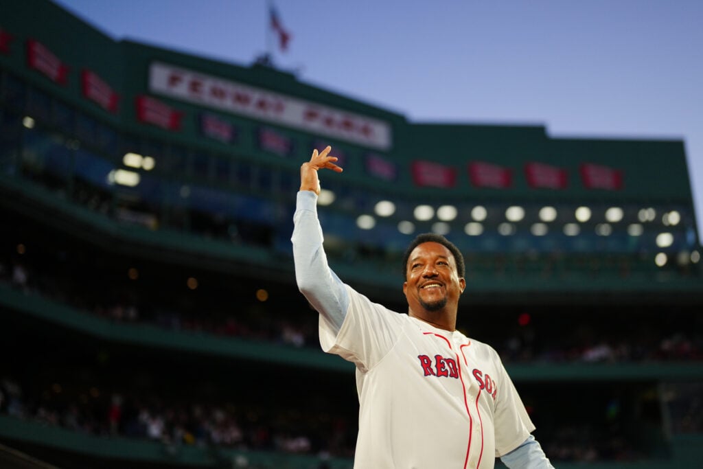 Pedro Martínez gestures to the crowd after throwing the ceremonial first pitch prior to the game between the New York Yankees and the Boston Red Sox at Fenway Park.