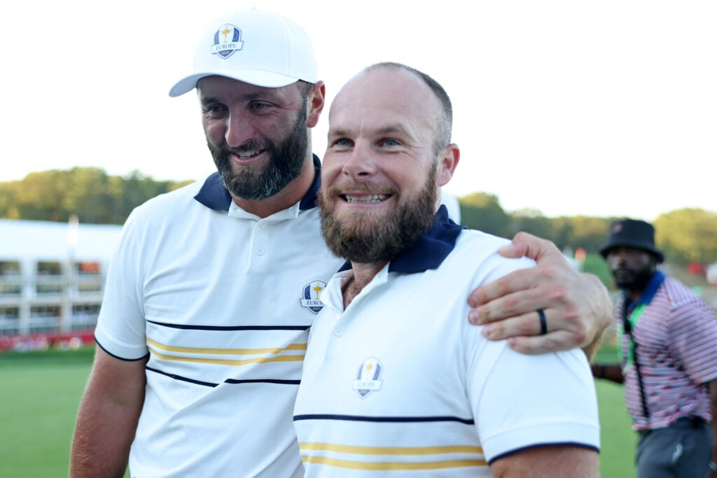 Jon Rahm and Tyrrell Hatton hug during the Sunday singles matches of the 2025 Ryder Cup at Bethpage Black