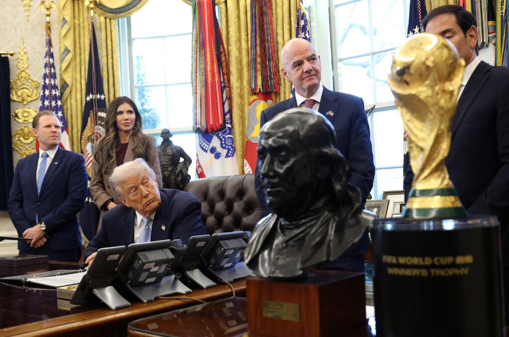 U.S. President Donald Trump, joined by FIFA President Gianni Infantino (2R), listens to remarks during a meeting of the White House Task Force on the FIFA World Cup 2026 in the Oval Office of the White House on November 17, 2025 in Washington, DC. The task force was created to oversee security, logistics, and federal government support for the 2025 Club World Cup and the 2026 FIFA World Cup hosted by the United States. The two were also joined by (L-R) Andrew Giuliani, Secretary of Homeland Security Kristi Noem, and Secretary of State Marco Rubio.