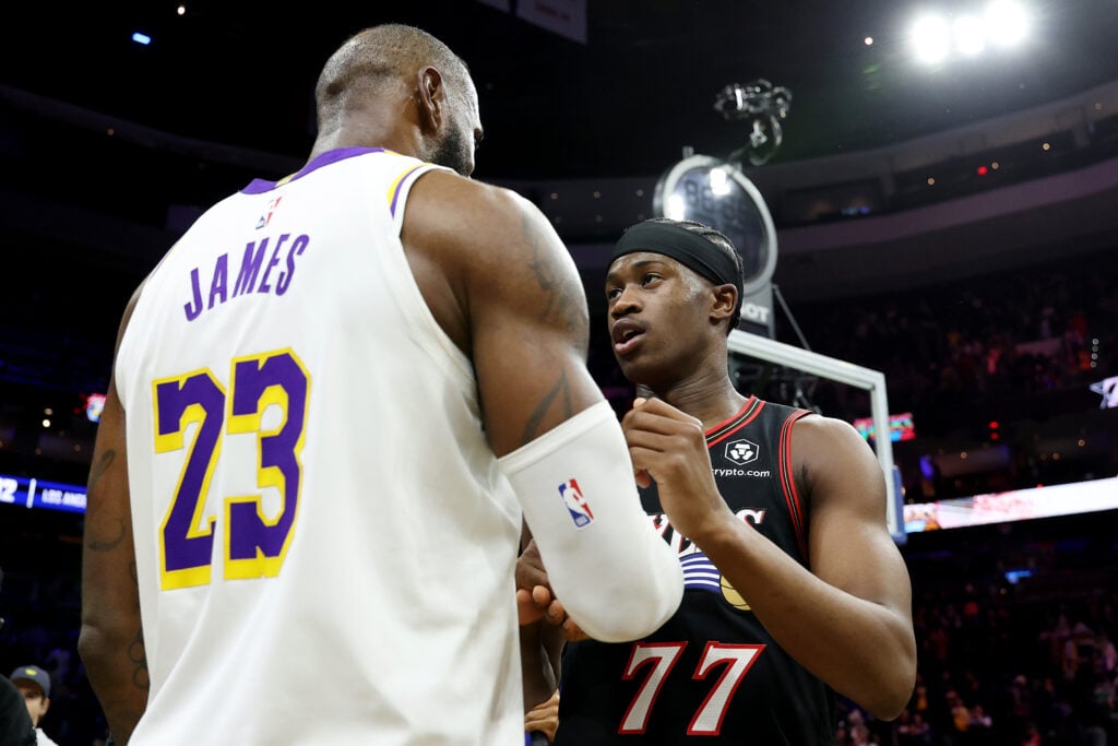 Vj Edgecombe #77 of the Philadelphia 76ers talks to Lebron James #23 of the Los Angeles Lakers after a game at Xfinity Mobile Arena on December 07, 2025 in Philadelphia, Pennsylvania. The Los Angeles Lakers won 112-108.
