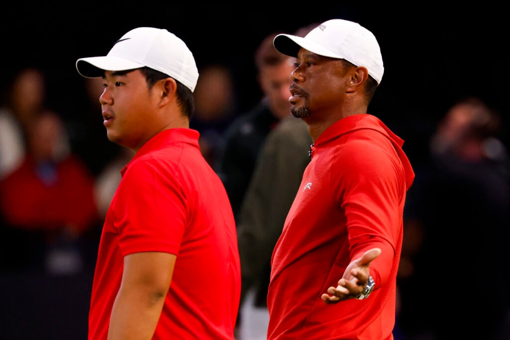 Tom Kim and Tiger Woods of Jupiter Links GC look on before a match against Boston Common Golf at SoFi Center