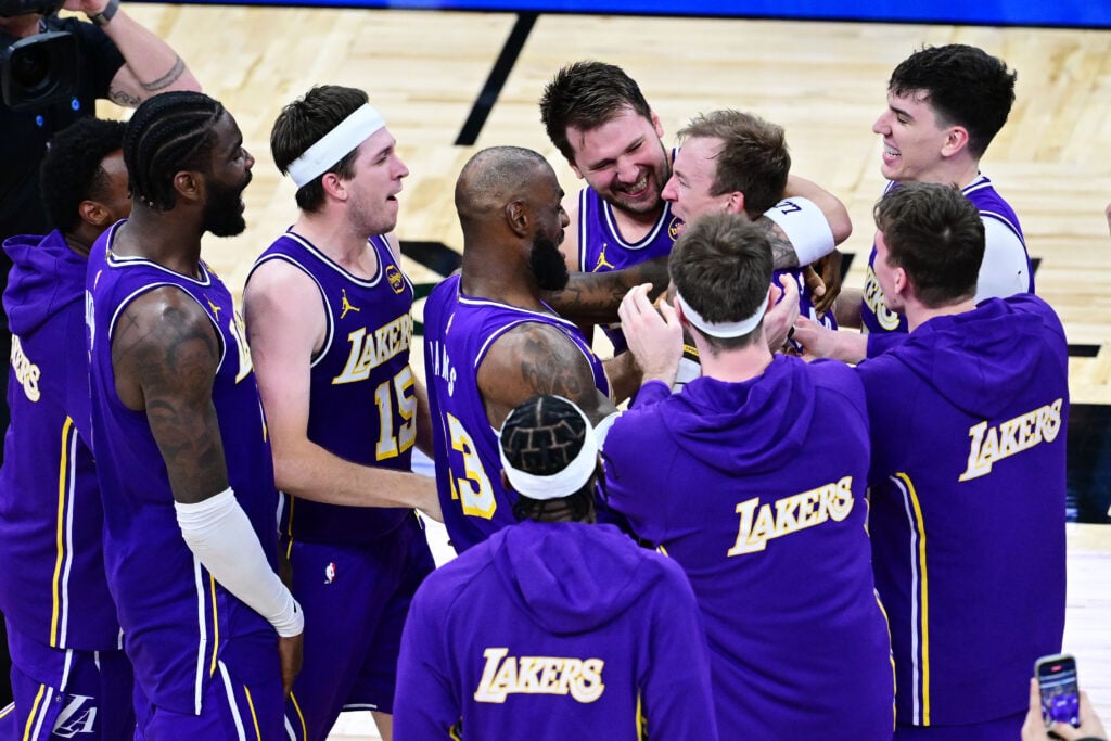 Luke Kennard #10 of the Los Angeles Lakers celebrates with Deandre Ayton #5, Austin Reaves #15, LeBron James #23, Luka Doncic #77, and Jake LaRavia #12 after scoring a go-ahead three-point-basket in the fourth quarter against the Orlando Magic at Kia Center on March 21, 2026 in Orlando, Florida.