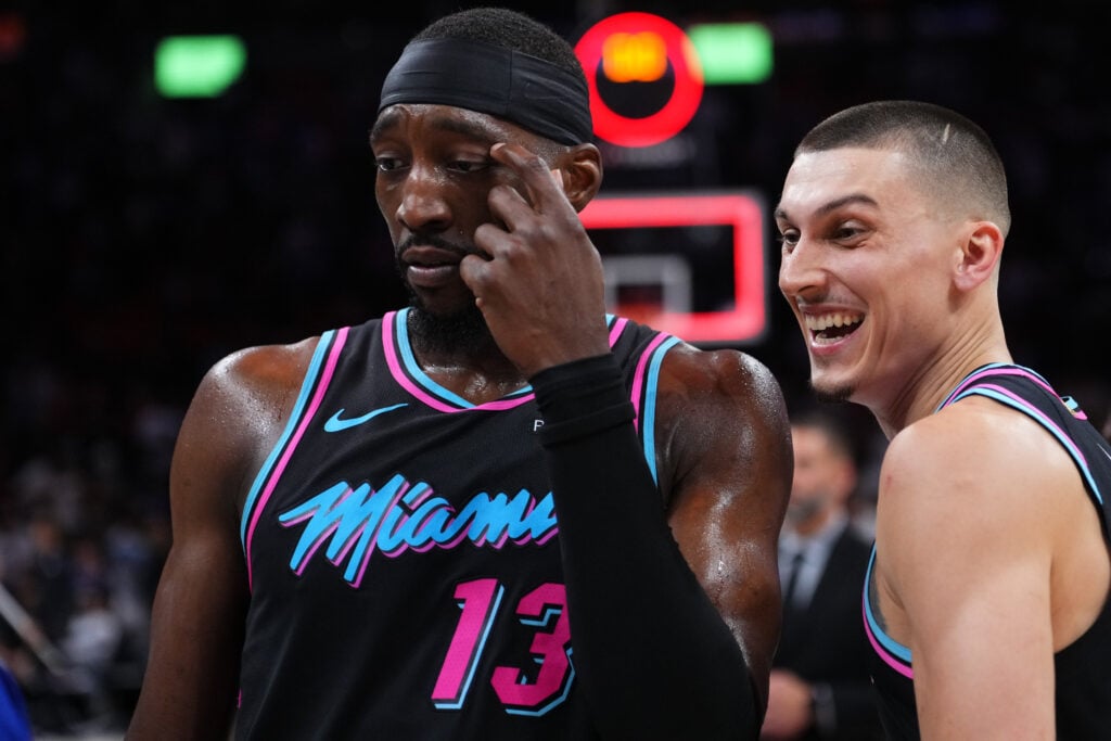 Bam Adebayo #13 and Tyler Herro #14 of the Miami Heat look on at the end of a game against the Philadelphia 76ers at Kaseya Center.