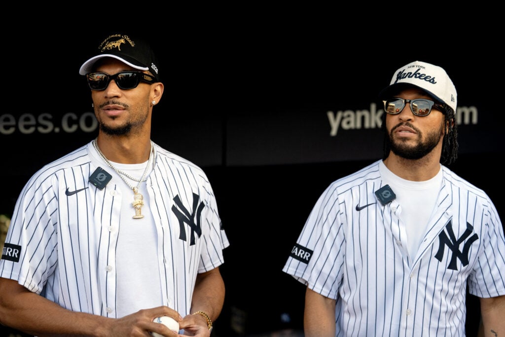 Jalen Brunson #11 of the New York Knicks and Josh Hart #3 look on before throwing out the first pitch prior to the game between the Chicago White Sox and the New York Yankees at Yankee Stadium