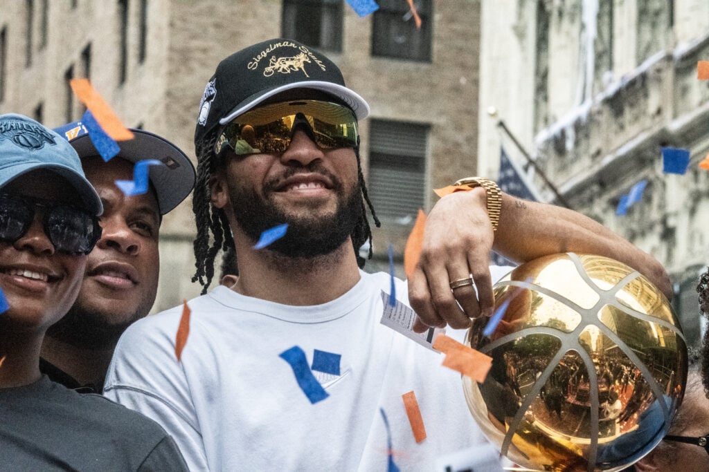 Jalen Brunson of the New York Knicks holds the trophy during the New York Knicks Championship ticker tape parade and victory rally celebrating winning the 2026 NBA Finals on June 18, 2026 in New York City. The New York Knicks defeated the San Antonio Spurs in five games to win their first NBA Championship in 53 years.