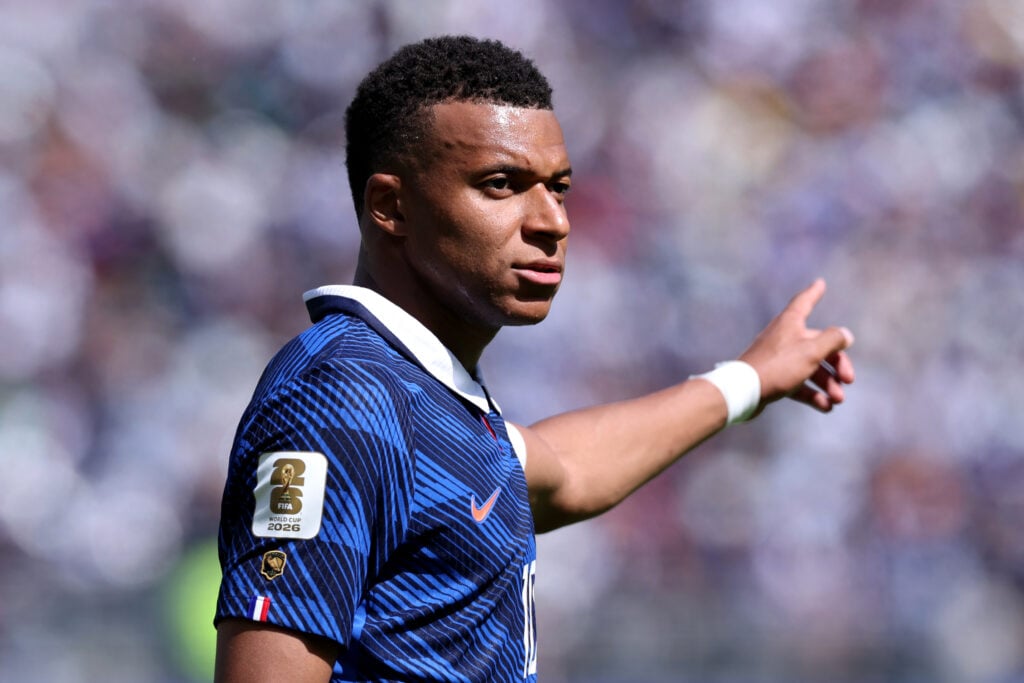 Kylian Mbappe #10 of France gestures, as his Golden Boot badge is seen on his shirt sleeve after winning the award at the FIFA Qatar World Cup 2022, during the FIFA World Cup 2026 Group I match between France and Senegal.