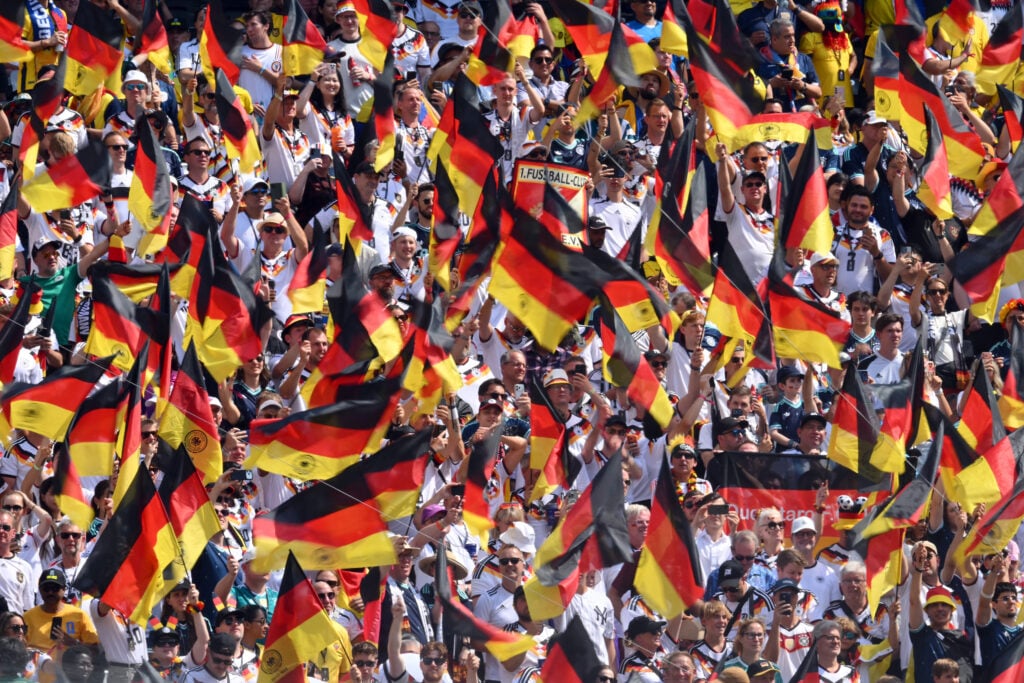 German fans wave national flags ahead of the 2026 World Cup Group E football match between Ecuador and Germany at the New York/New Jersey Stadium.