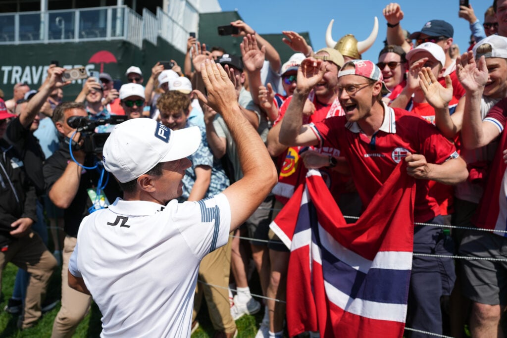 Viktor Hovland of Norway celebrates with Norwegian fans, after the playoff hole, after the final round of the Travelers Championship