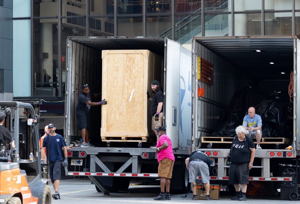 Crew members are seen unloading trucks and transporting large boxes and items under tarps into Madison Square Garden in preparation for the rumored wedding of Taylor Swift and Travis Kelce on June 30, 2026 in New York, New York.