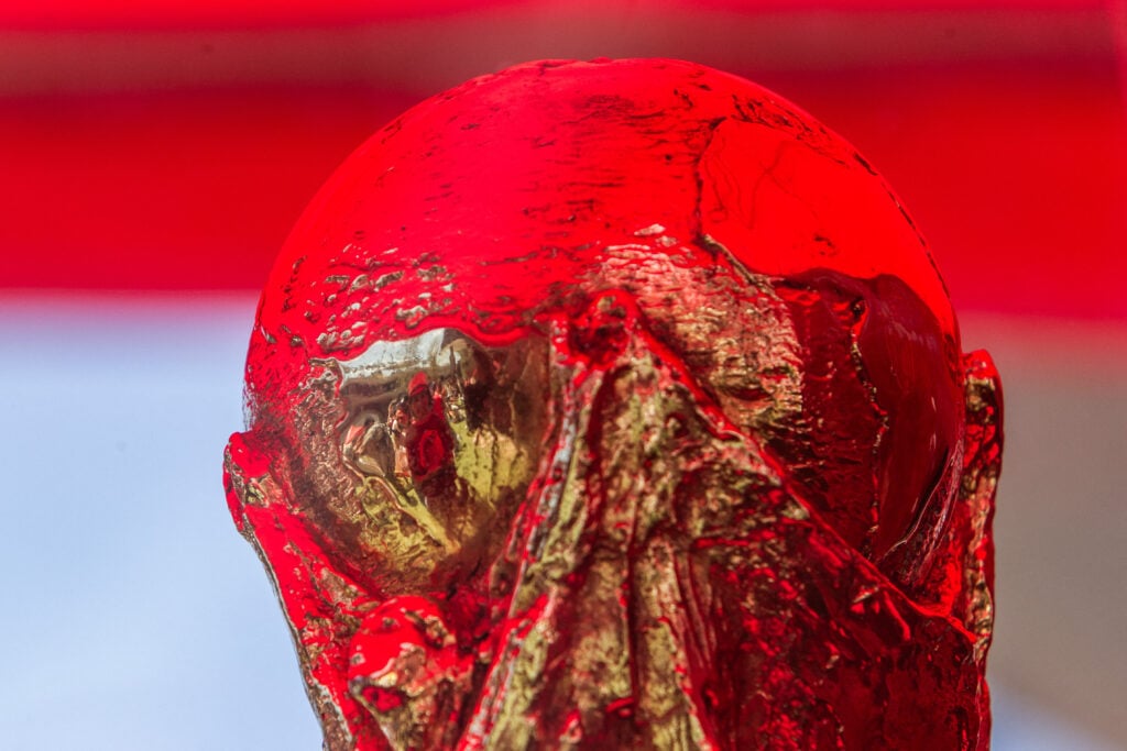 The World Cup trophy won by Spain in 2010 is displayed as people gather to watch the 2026 FIFA World Cup Round of 32 football match between Spain and Austria at the Casa Espana fan zone hosted by the Royal Spanish Football Federation (RFEF), at Ivy Station in Culver City, California, on July 2, 2026. (Photo by Apu GOMES / AFP via Getty Images)