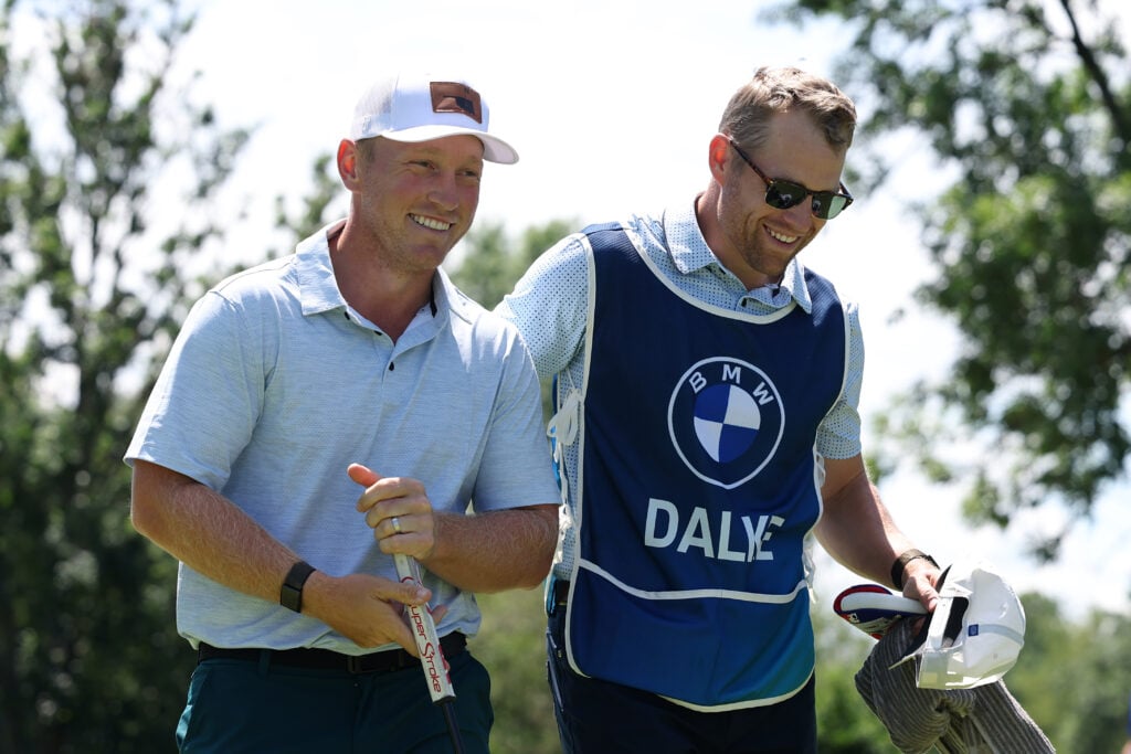 Brad Dalke of the United States reacts with his caddie after finishing his round on the ninth green on day two of the BMW International Open