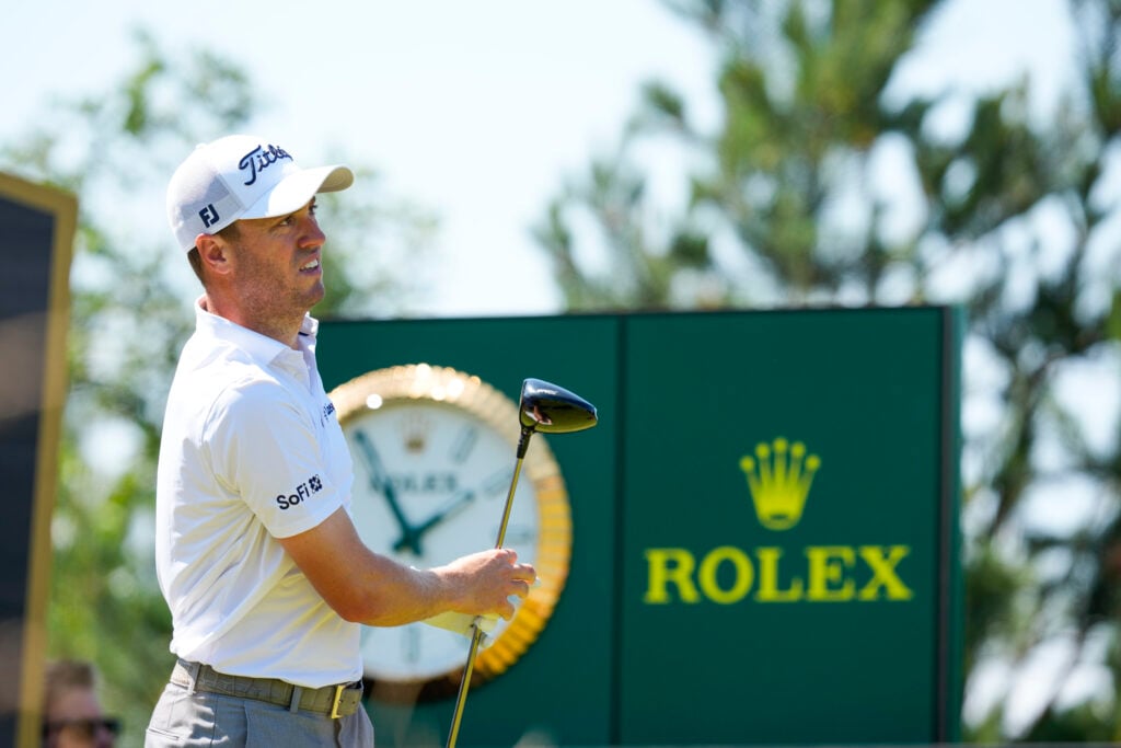 Justin Thomas watches his shot on the first hole during the first round of Genesis Scottish Open at The Renaissance Club