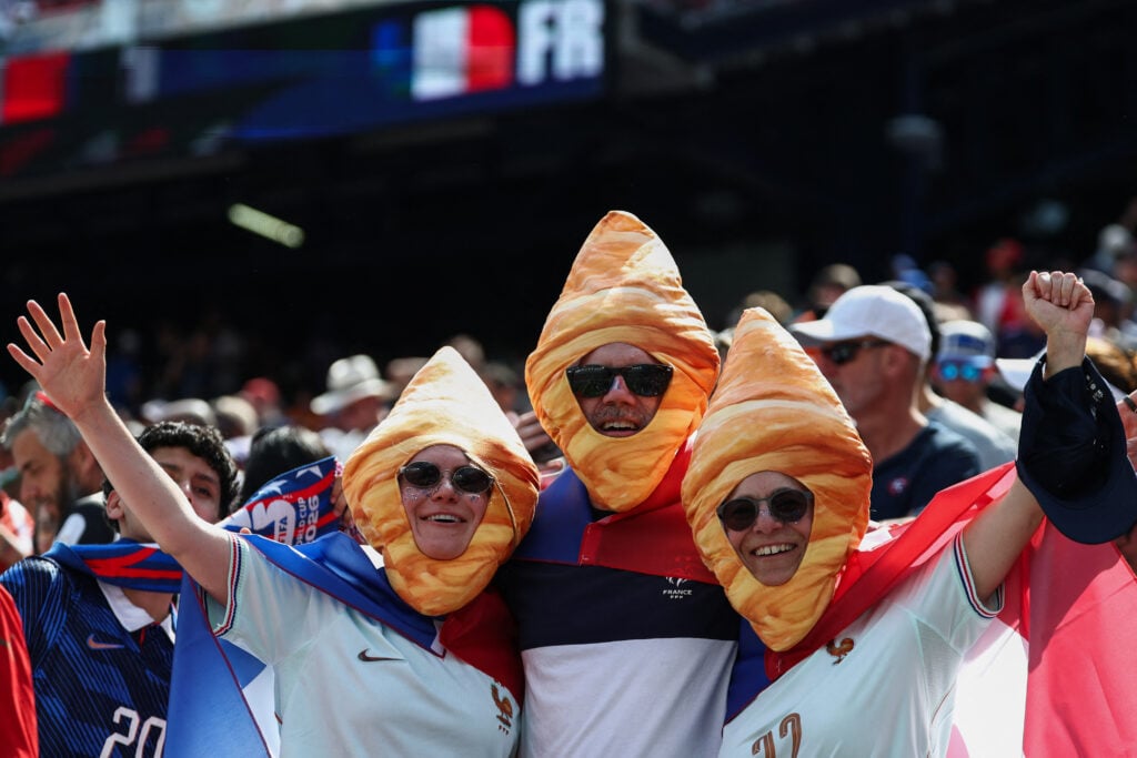 French fans wearing croissant costumes pose for a photo ahead of the 2026 World Cup football tournament quarter-final match between France and Morocco at Boston Stadium.