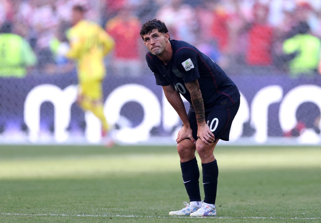 Christian Pulisic #10 of the United States reacts after Belgium's third goal during the FIFA World Cup 2026 Round of 16 match between USA and Belgium at Seattle Stadium.