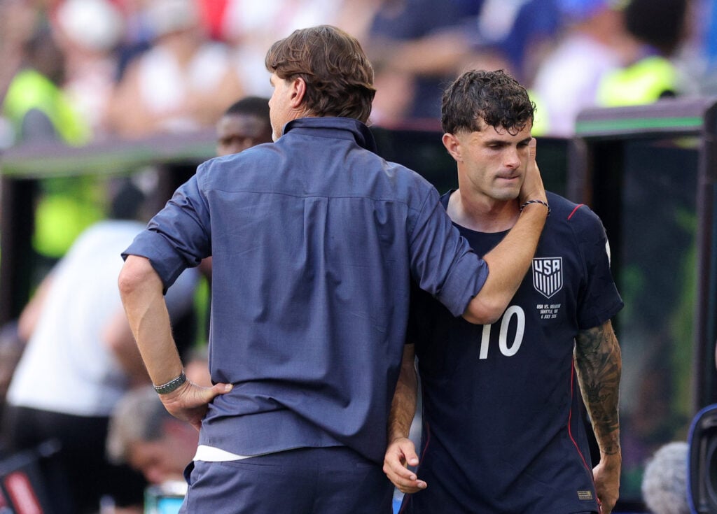 Christian Pulisic #10 of the United States is consoled by Mauricio Pochettino, Head Coach of the United States, after being substituted during the FIFA World Cup 2026 Round of 16 match between USA and Belgium at Seattle Stadium