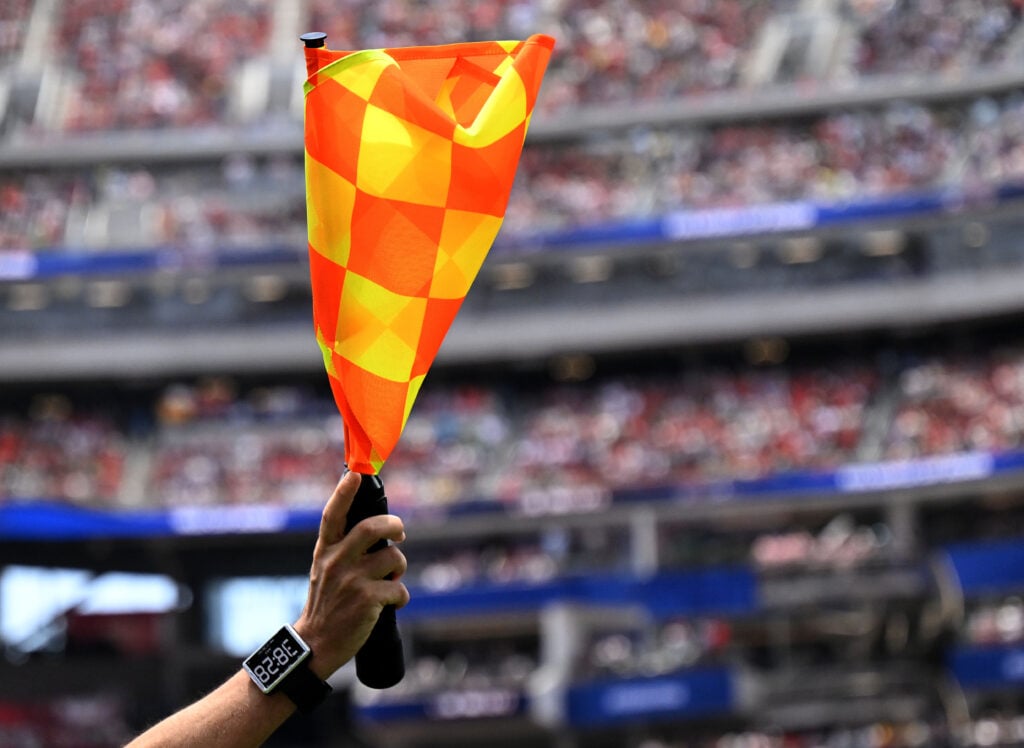 A linesman throws up the offside flag during the Spain and Belguim match at Los Angeles Stadium in Inglewood on Friday, July 10, 2026.