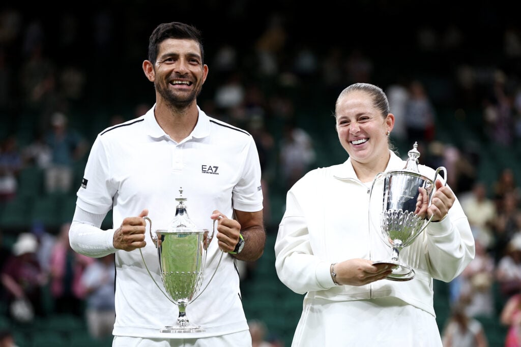 Marcelo Arevalo of El Salvador and Jelena Ostapenko of Latvia pose for a photo with their trophies following victory over Marc Polmans of Australia and Storm Hunter of Australia during their Mixed Doubles final match