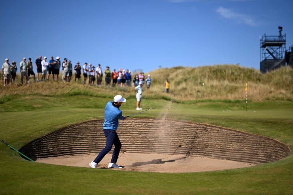Jordan Spieth of the United States plays out of a bunker on the 11th hole during a practice round, prior to The 154th Open Championship