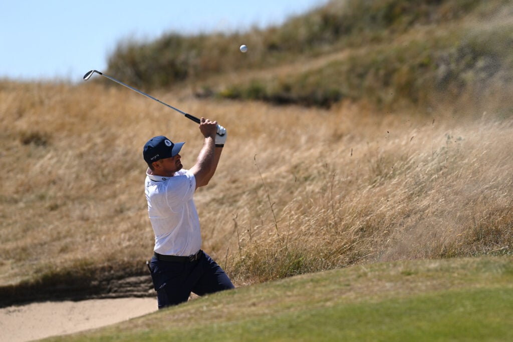Bryson DeChambeau practices from a bunker during a practice round at Royal Birkdale ahead of The Open Championship