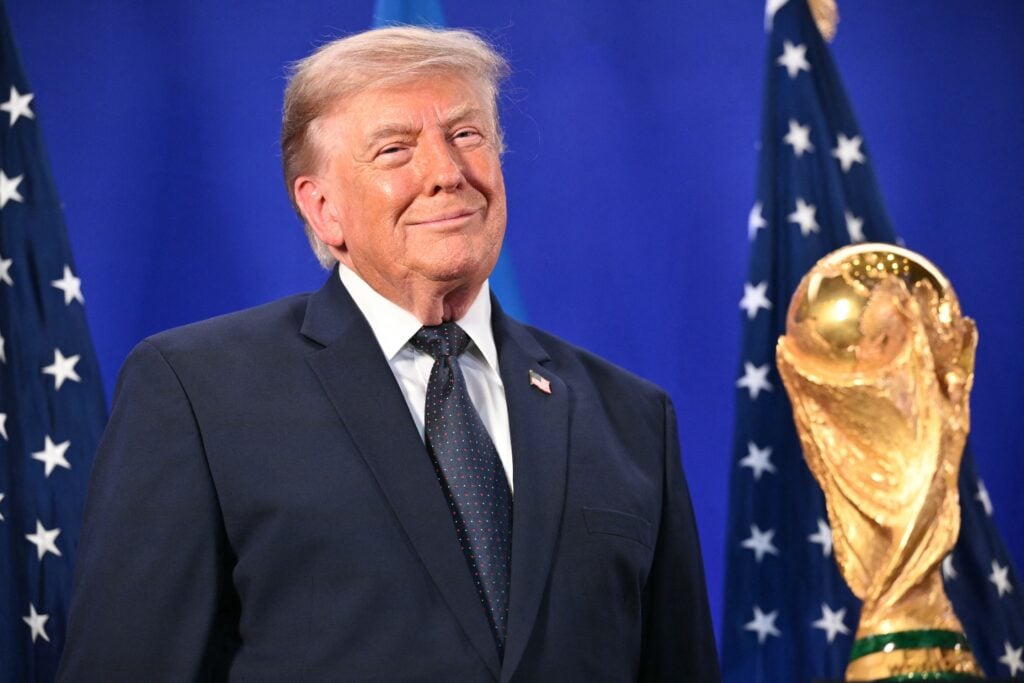 US President Donald Trump stands by the FIFA World Cup Trophy as he listens to FIFA President Gianni Infantino (off frame) speak during a FIFA reception at Trump Tower.