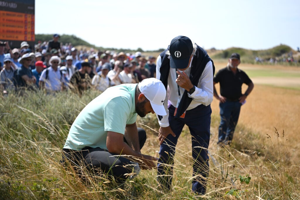 Scottie Scheffler of the United States speaks to a rules official on the 17th hole during Day One of the The 154th Open Championship at Royal Birkdale