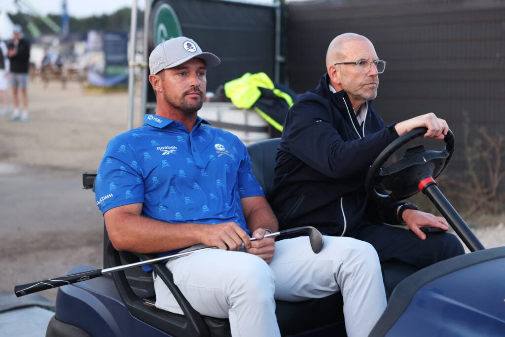 Bryson DeChambeau of the United States is driven by a rules offical on a buggy following day two of the The 154th Open Championship