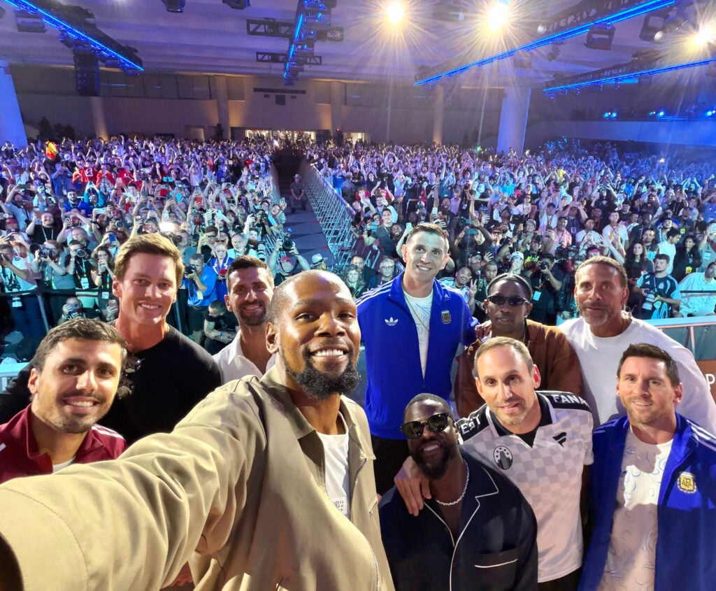 Houston Rockets power forward Kevin Durant takes a selfie with Rodri #16 of Spain, American football player Tom Brady, Serbian tennis player Novak Djokovic, Emiliano Martinez #23 of Argentina, American comedian and actor Kevin Hart, American rapper and singer-songwriter Travis Scott, Former football player Rio Ferdinand, American businessman Michael Rubin and Lionel Messi #10 of Argentina during a press conference ahead of the FIFA World Cup 2026 Final at Fanatics Fest at Javits Center.