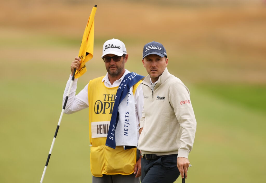 Russell Henley of the United States interacts with his caddie on the sixth green on day three of the The 154th Open Championship at Royal Birkdale