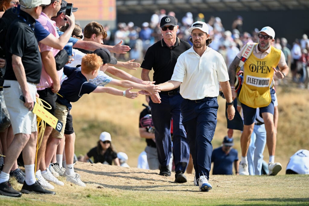 Tommy Fleetwood high fives the crowd during the third round of The Open Championship