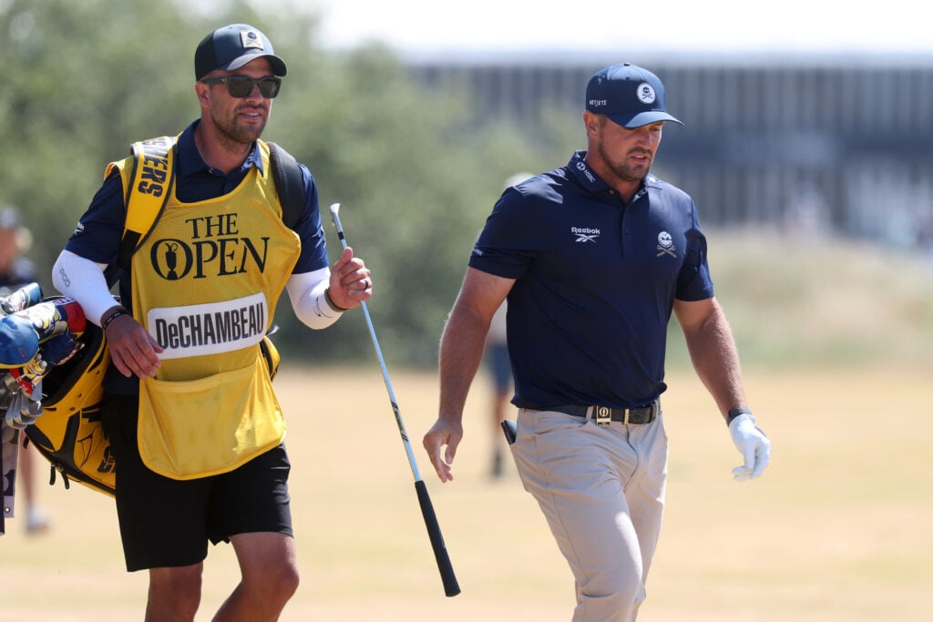 Bryson DeChambeau of the United States and his caddie, Greg Bodine walk on the first hole on day four of the The 154th Open Championship at Royal Birkdale