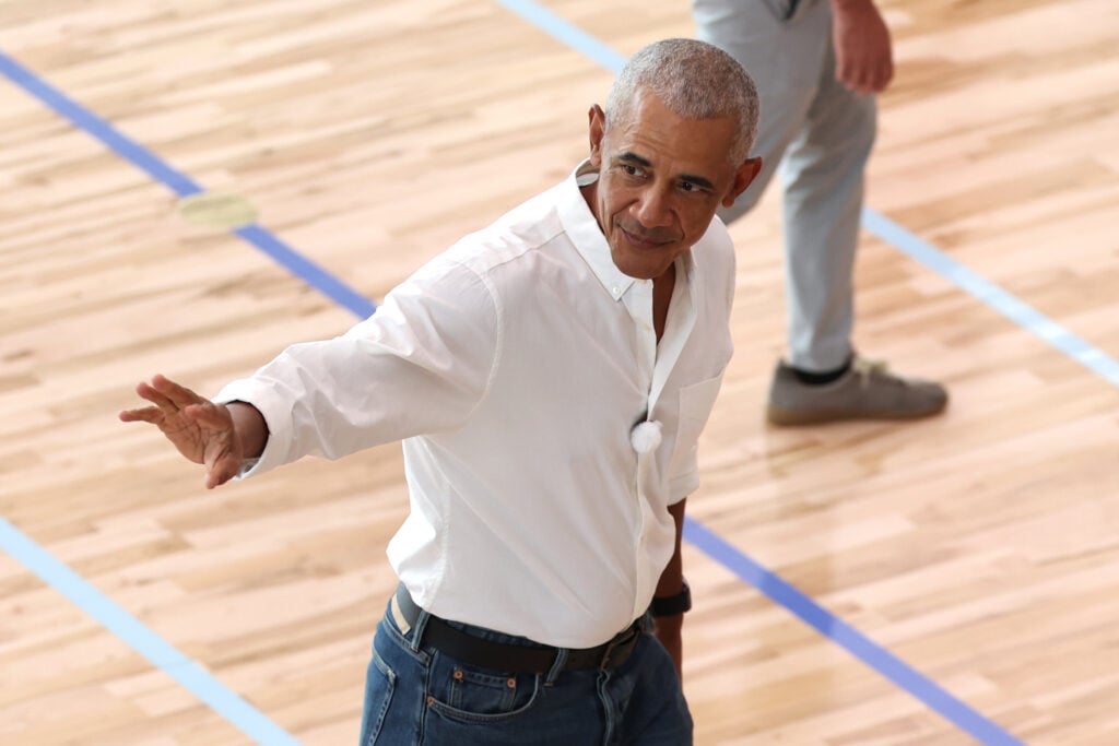 Former U.S. President Barack Obama waves to players at Obama Presidential Center