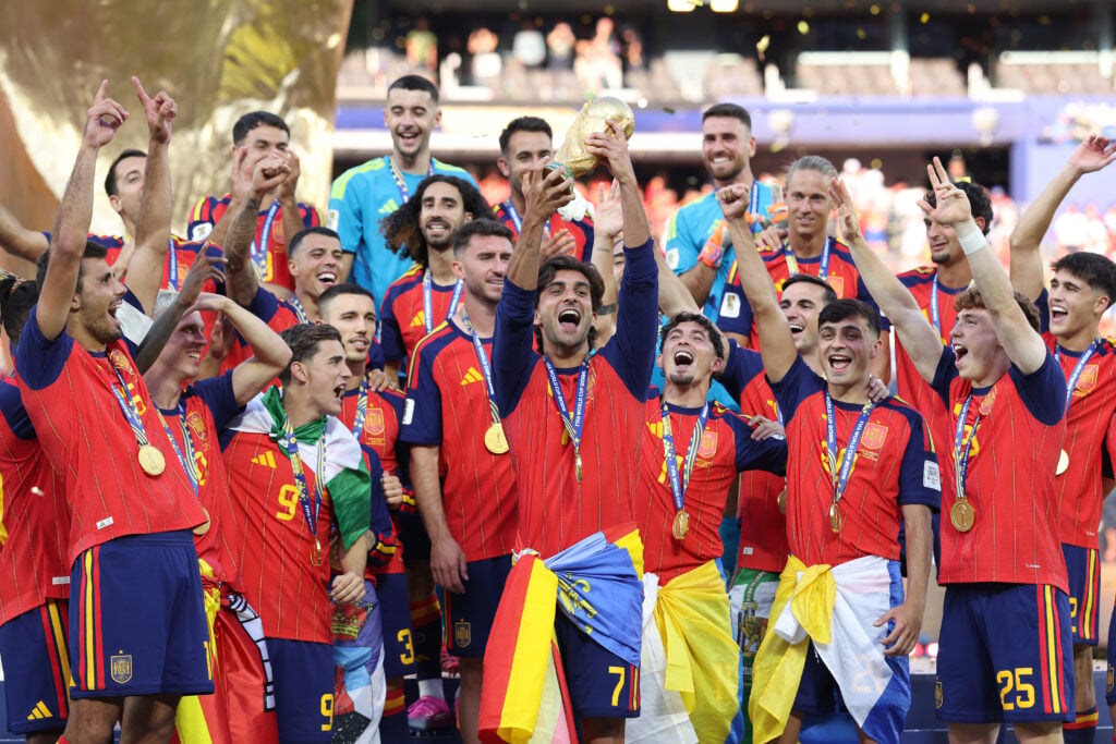 Ferran Torres of Spain celebrates by lifting the FIFA World Cup trophy after the FIFA World Cup 2026 Final match between Spain and Argentina at New York New Jersey Stadium.