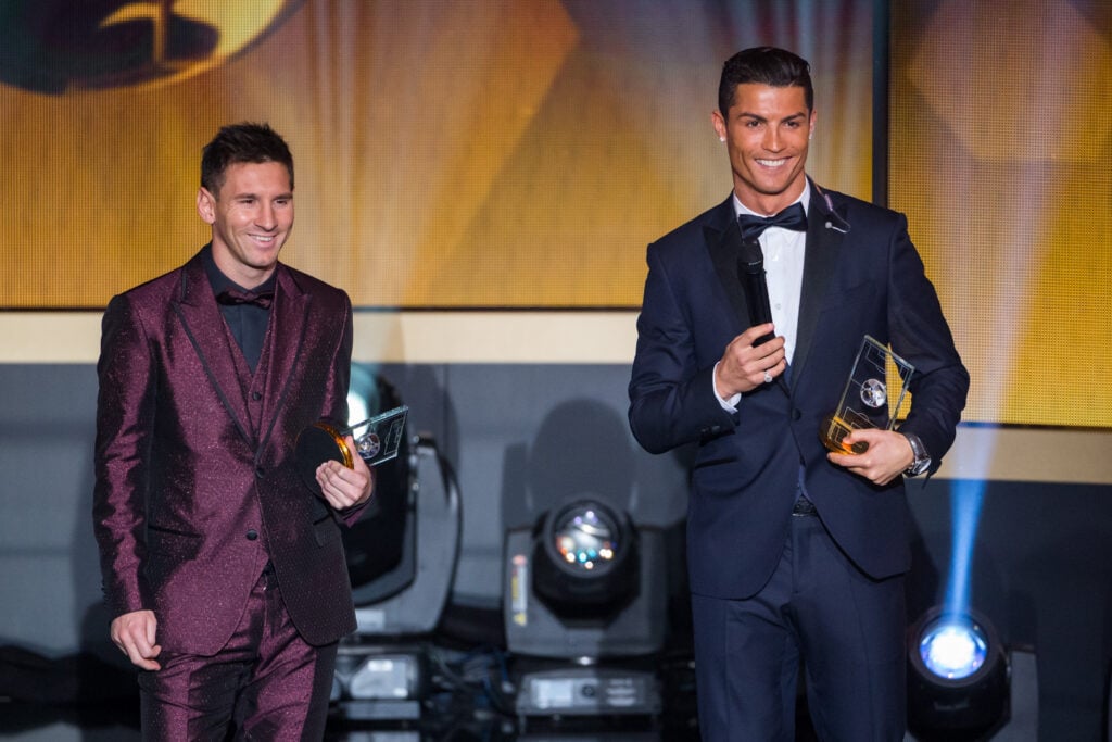 FIFA Ballon d'Or nominees Lionel Messi of Argentina and FC Barcelona (L) and Cristiano Ronaldo of Portugal and Real Madrid smile during the FIFA Ballon d'Or Gala 2014 at the Kongresshaus