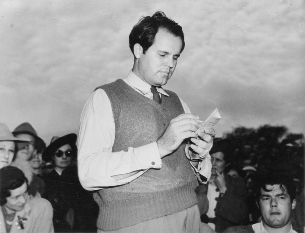 Ralph Guldahl checks his scorecard during the 1939 Masters, an event he would win