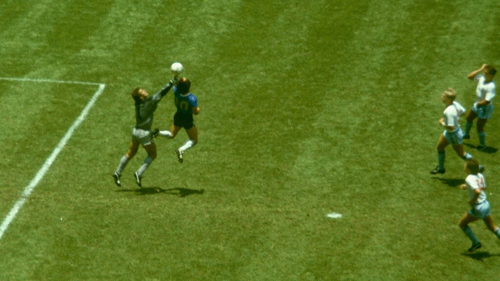 rgentina player Diego Maradona outjumps England goalkeeper Peter Shilton to score with his 'Hand of God' goal as England defenders Kenny Sansom (top) Gary Stevens (c) and Terry Fenwick look on during the 1986 FIFA World Cup Quarter Final at the Azteca Stadium.