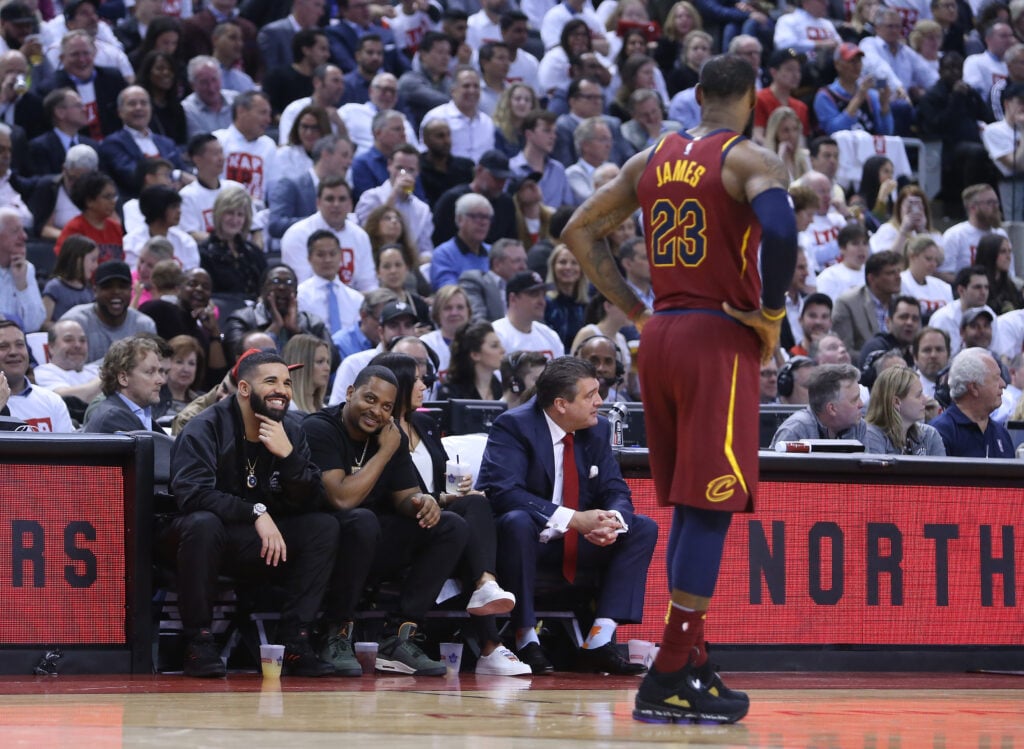 Drake talks to LeBron James #23 of the Cleveland Cavaliers from his court side seat in the first half of Game One of the Eastern Conference Semifinals against the Toronto Raptors during the 2018 NBA Playoffs at Air Canada Centre on May 1, 2018.