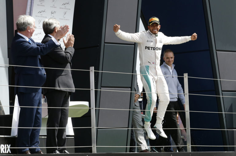 Mercedes' Lewis Hamilton celebrates after winning the race (REUTERS)